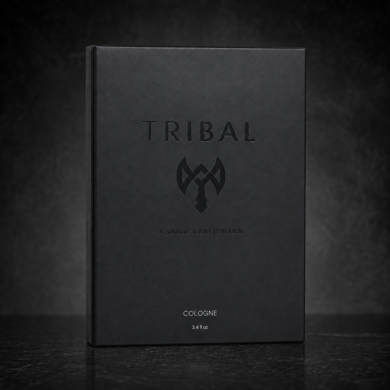 A matte black rectangular box for Tribal Cologne, featuring a debossed brand name and logo, set against a dark textured background.